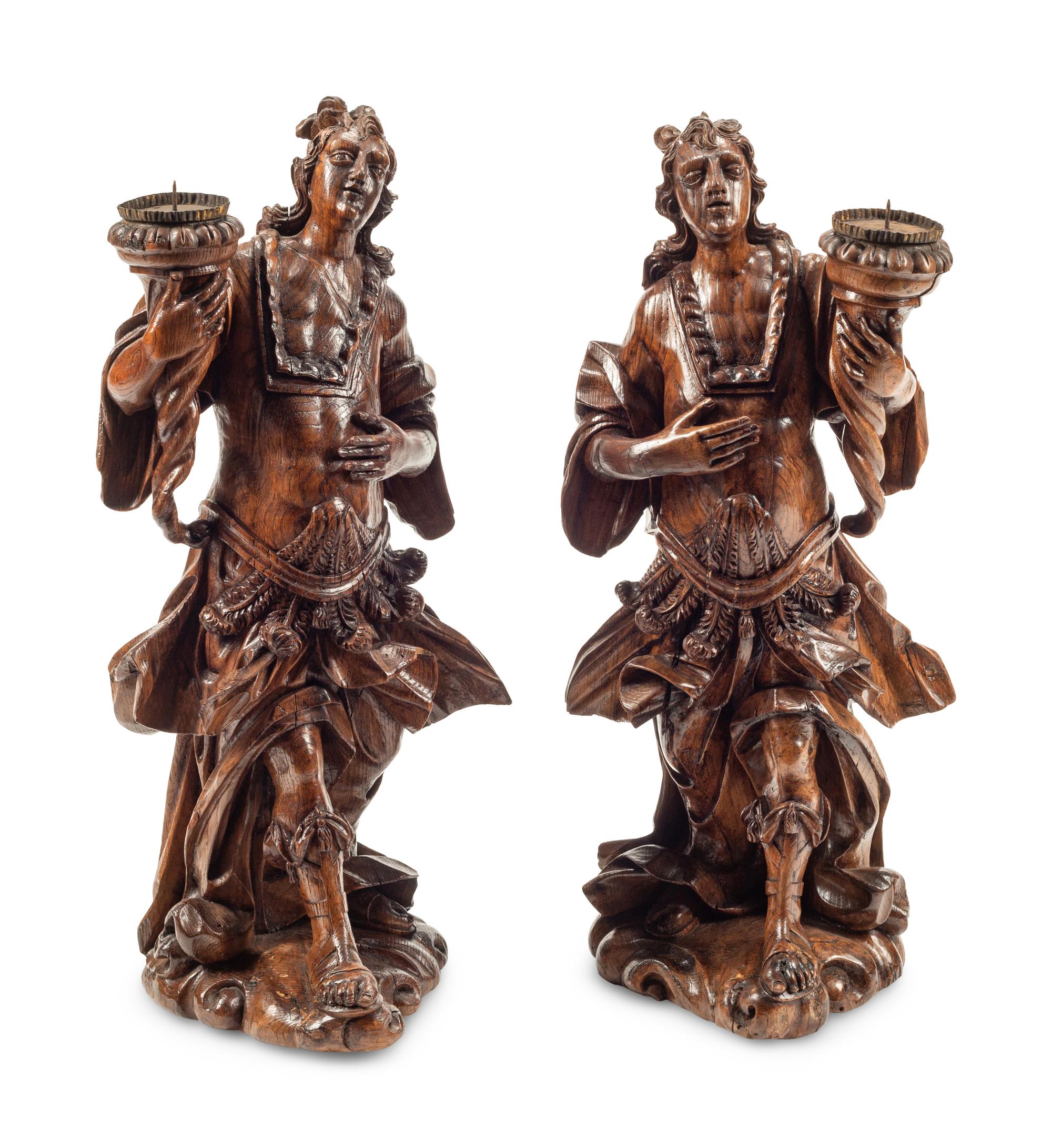 A Pair of Continental Carved Wood Figural Prickets