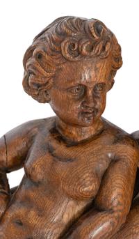 A Continental Carved Oak Figural Clock Case
