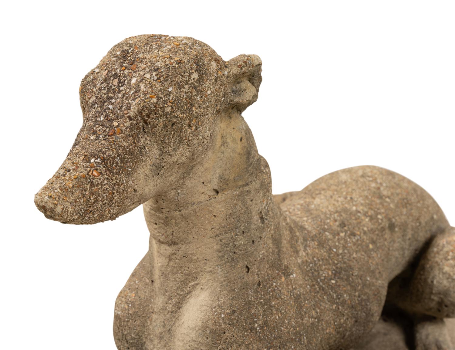 A Pair of Cast Stone Models of Recumbent Dogs