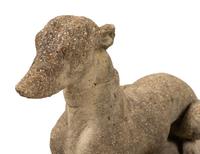 A Pair of Cast Stone Models of Recumbent Dogs