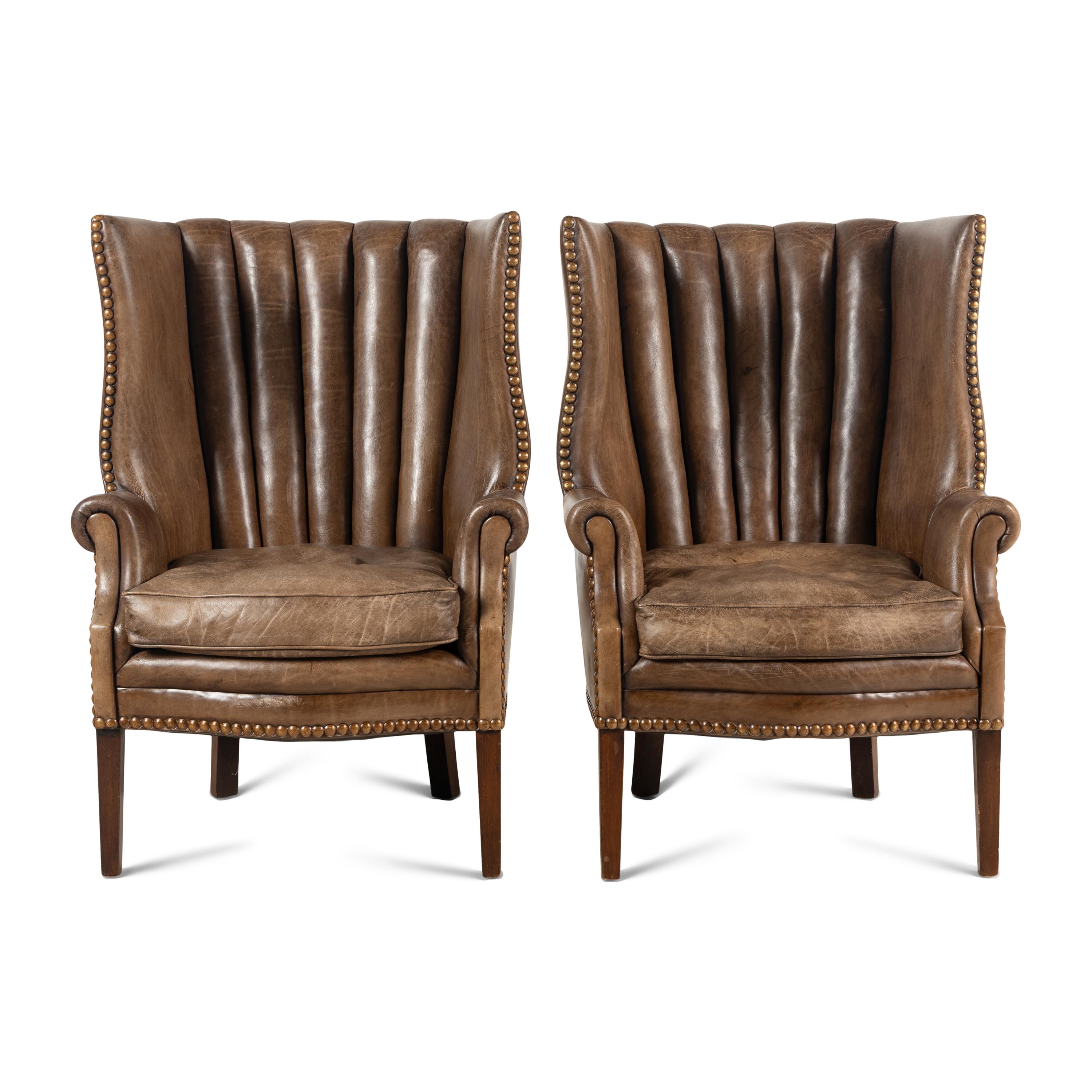 A Pair of Leather Upholstered Wingback Chairs
