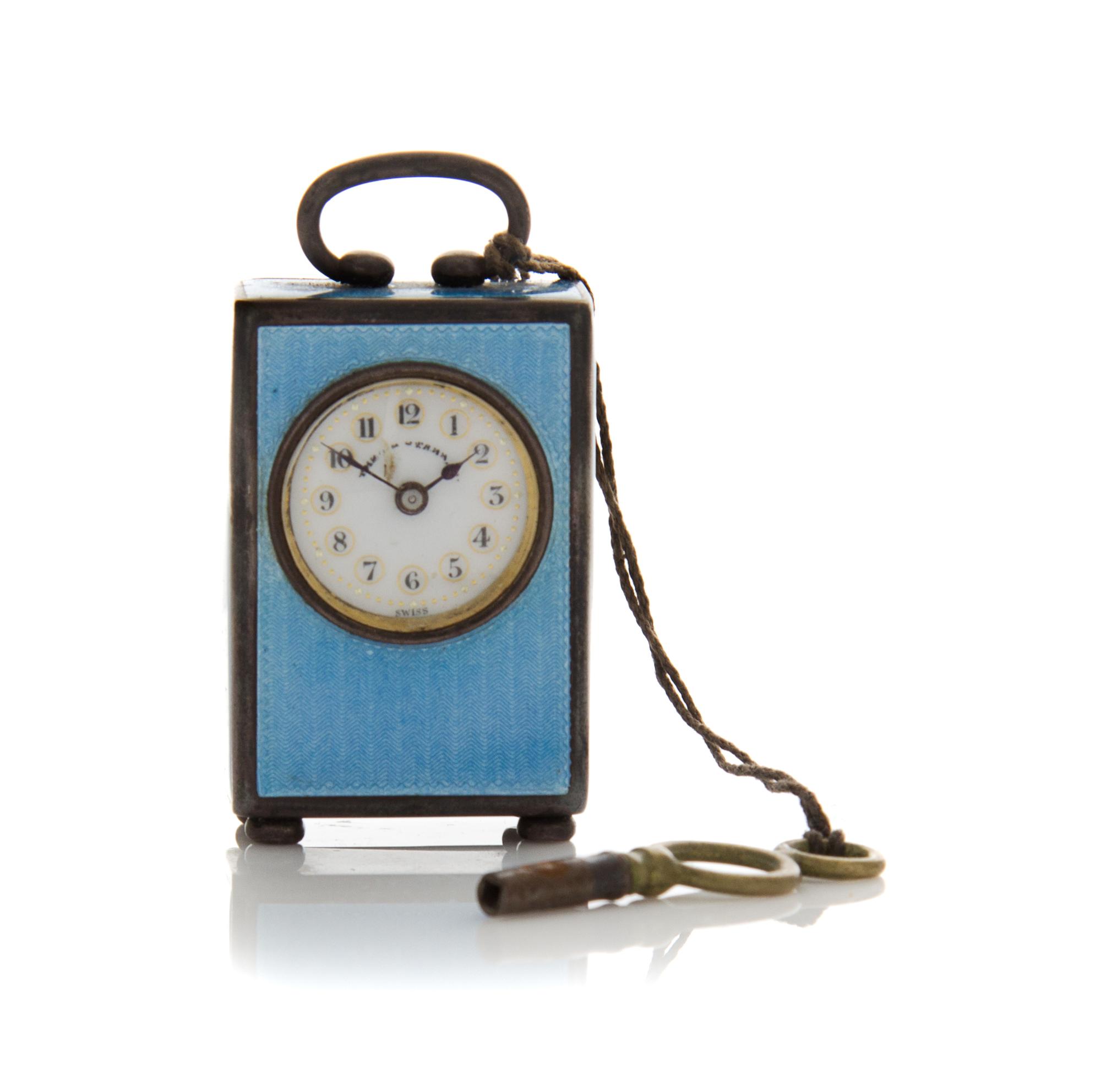 A Swiss Miniature Silver and Guilloche Enamel Clock, 19th/20th Century, set in a handled, rectangular case, the dial with Arabic numera