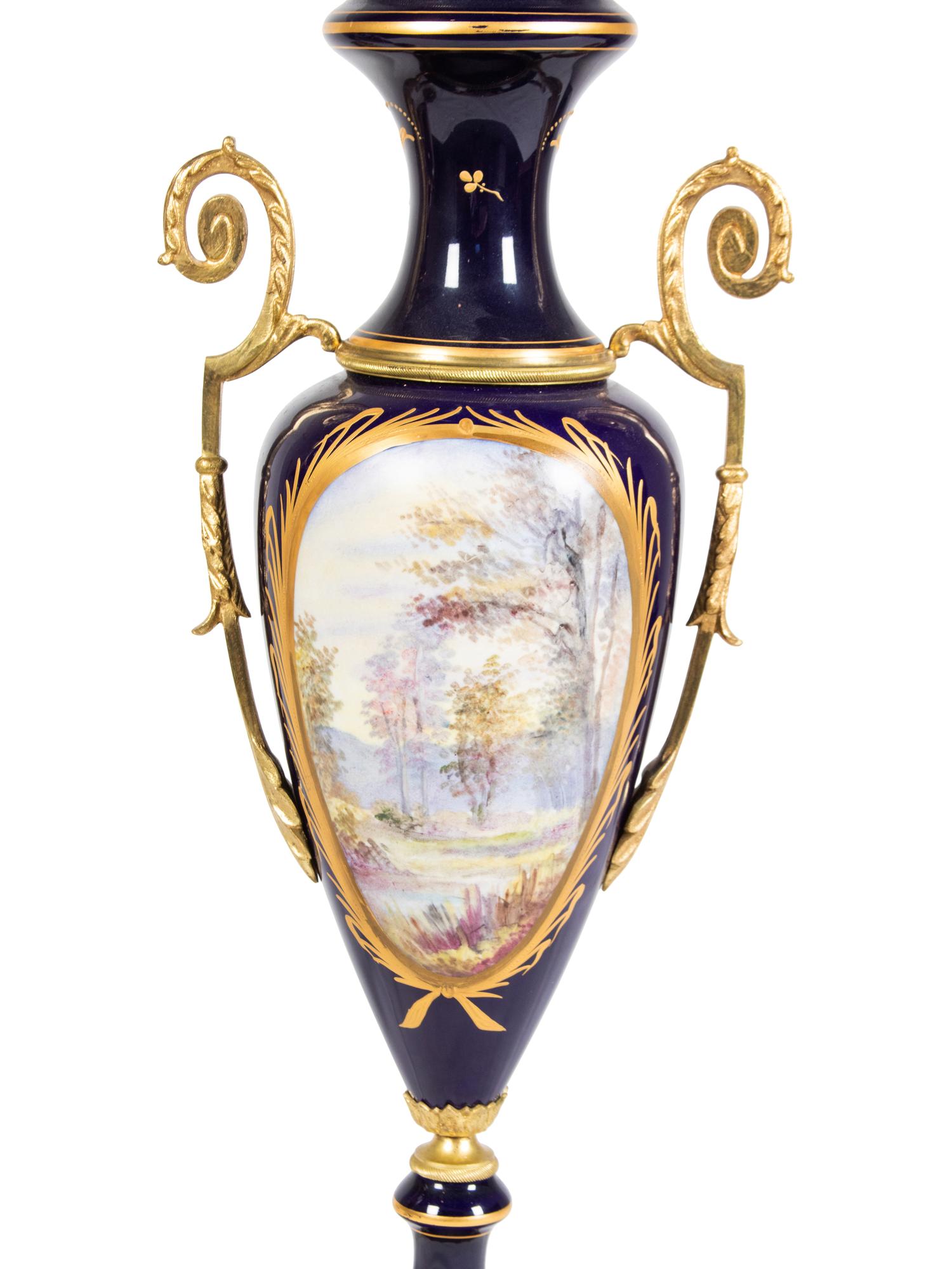 A Pair of Sèvres Style Gilt Metal Mounted Porcelain Covered Urns