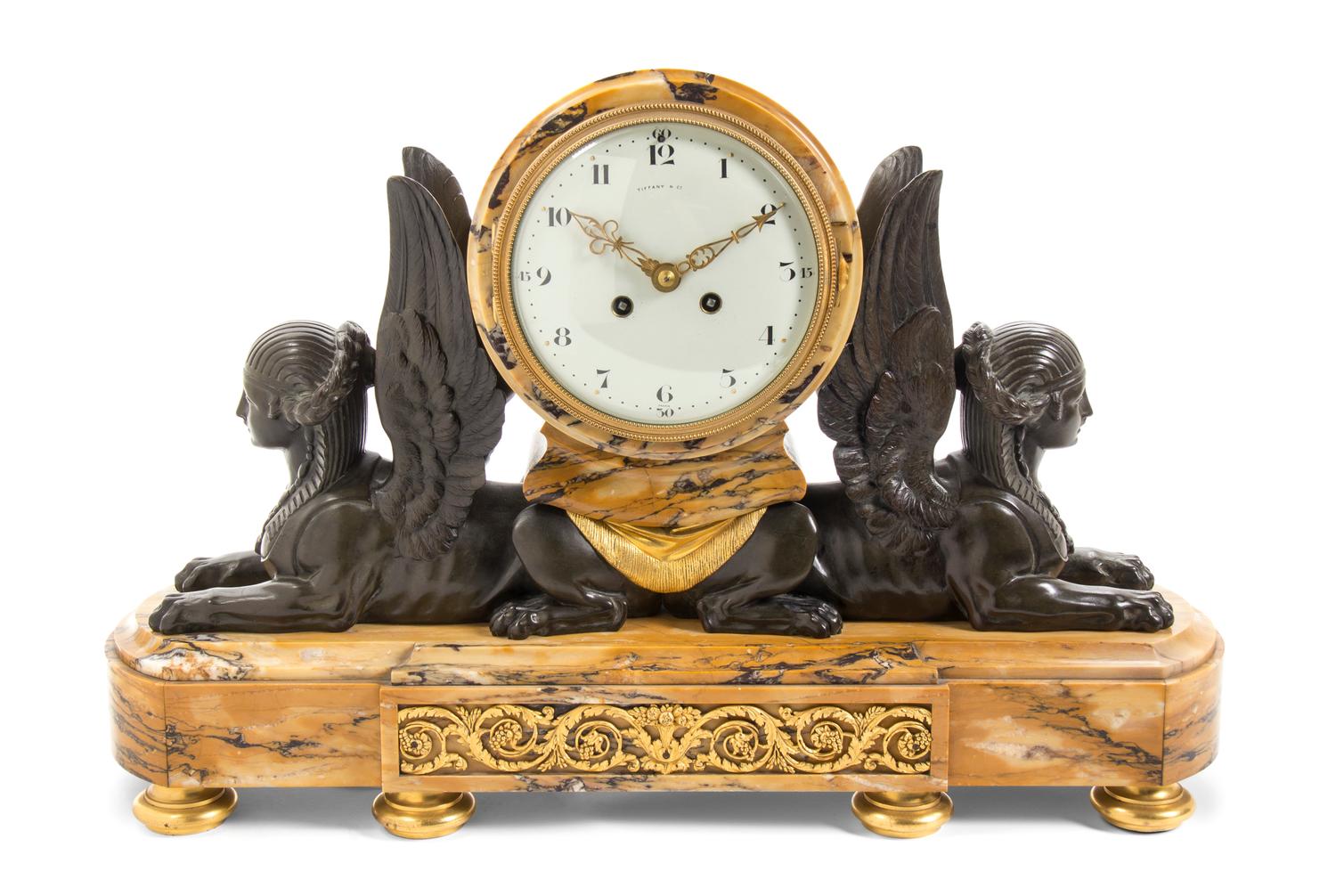 A French Marble and Patinated Bronze Mantel Clock, Tiffany & Co., Width 21 inches.