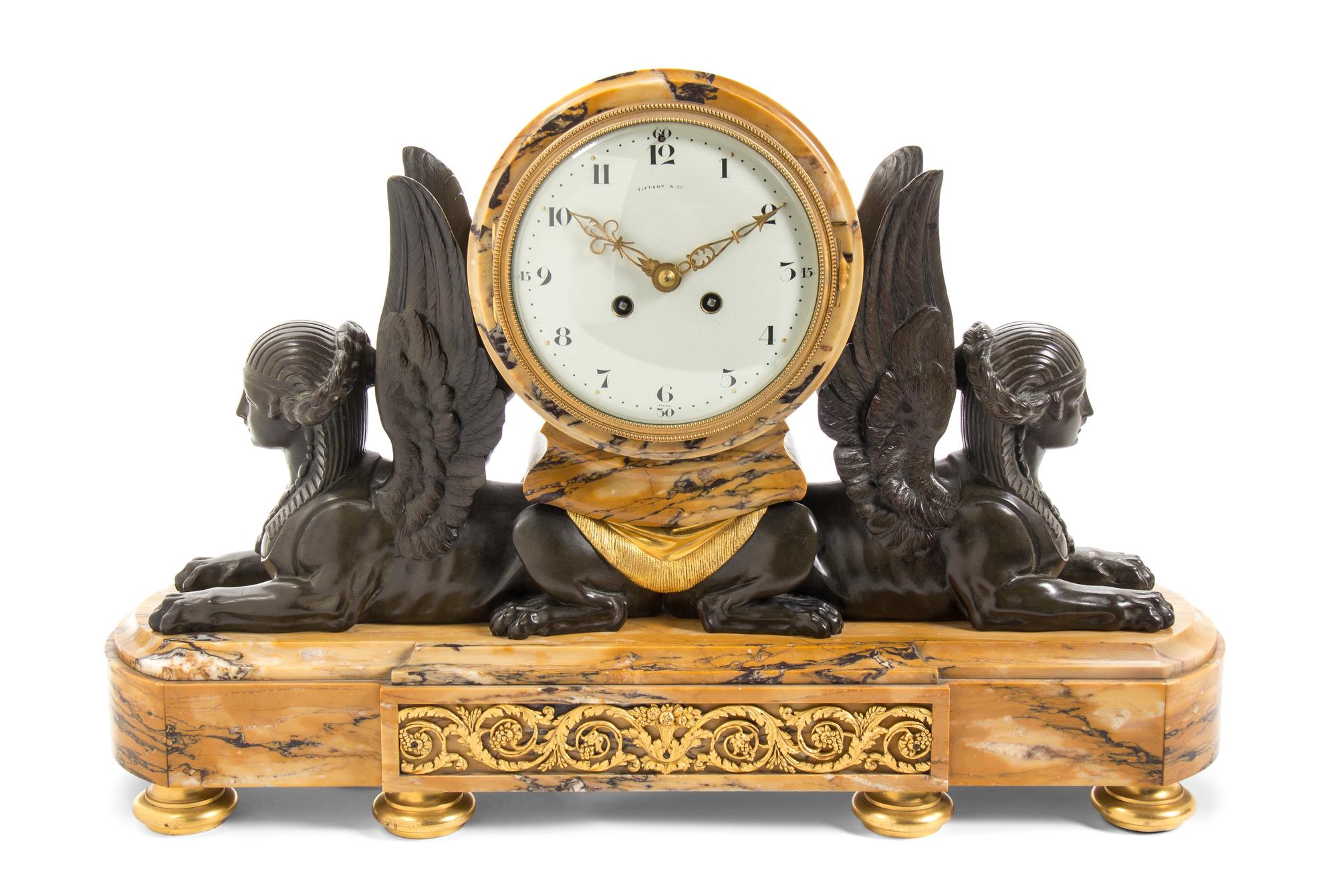 A French Marble and Patinated Bronze Mantel Clock, Tiffany & Co., Width 21 inches.