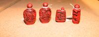 A Group of Four Cinnabar Snuff Bottles. Height of tallest 3 1/8 inches.