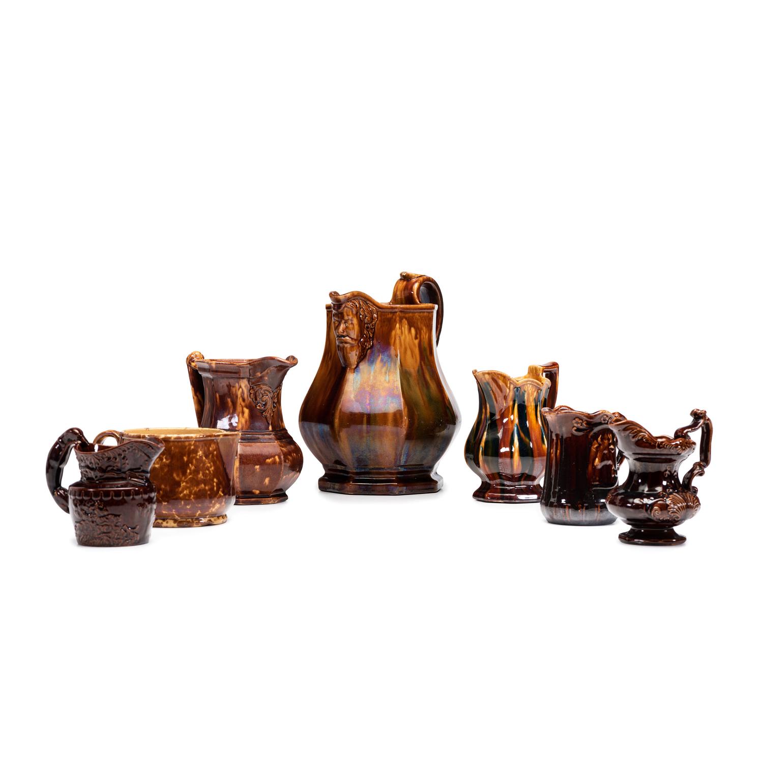 Seven Rockingham Glaze Pitchers