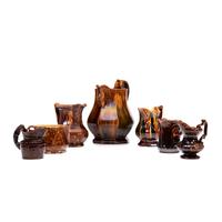Seven Rockingham Glaze Pitchers