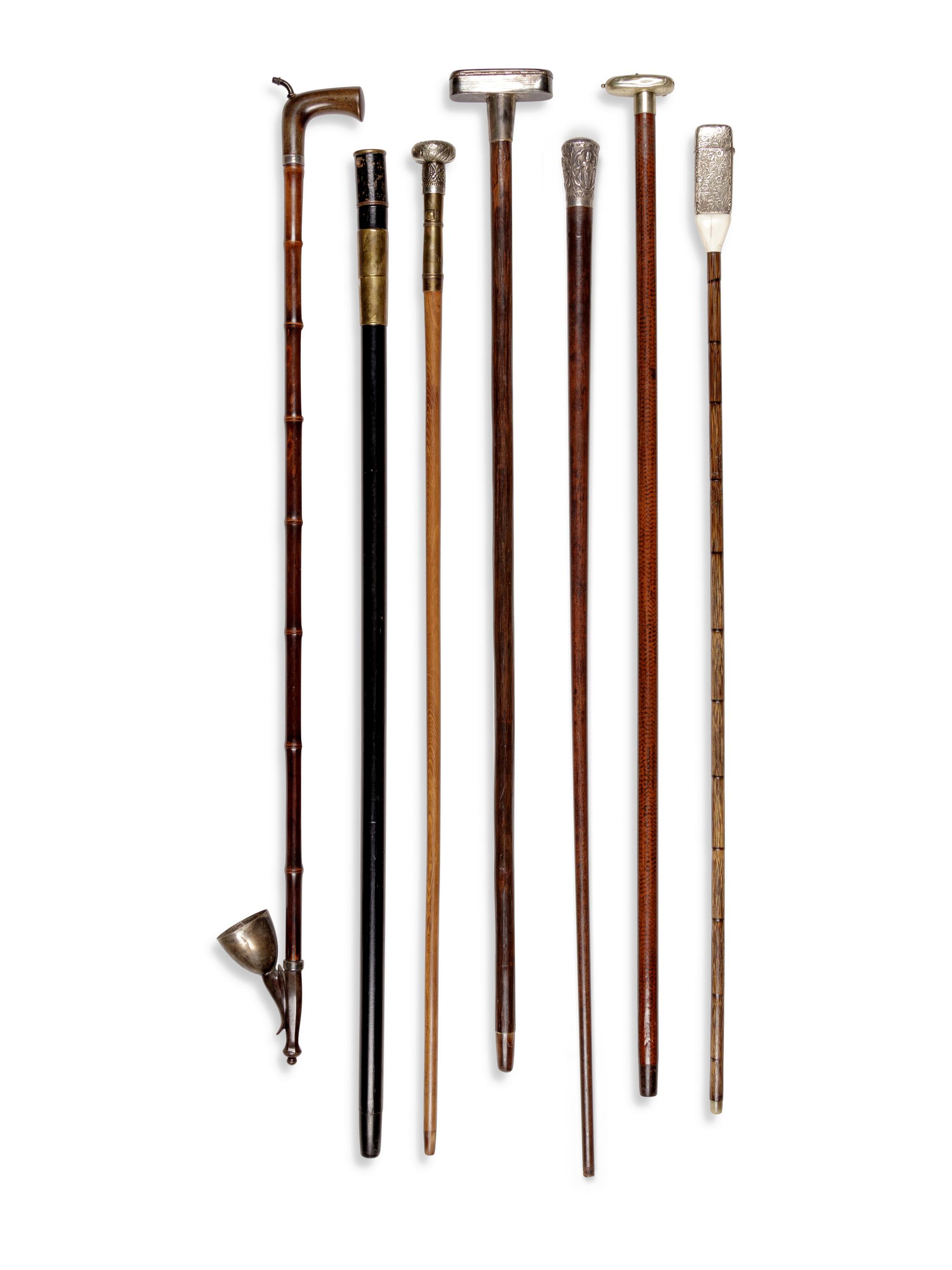 Seven Silvered Metal and Brass Mounted Smoker's System Walking Sticks