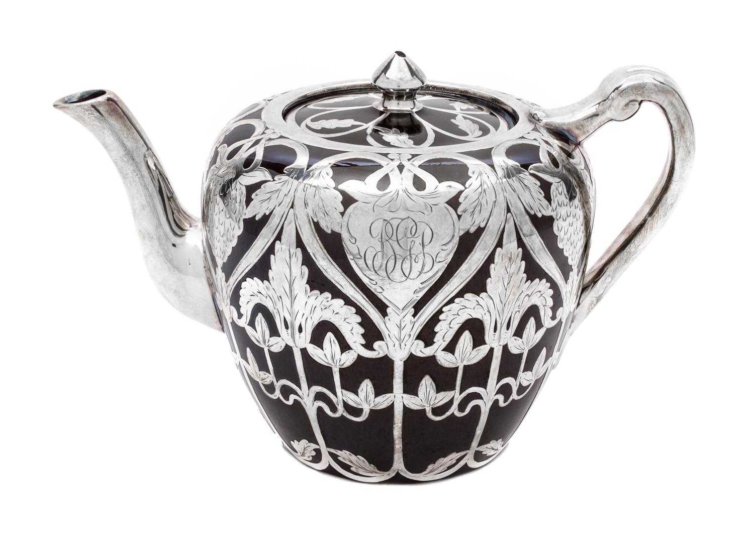 A Porcelain Silver Overlay Teapot Height 5 1/4 inches.