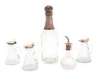 A Group of English Silver Capped Cruets and Bottles, Various Makers, comprising three glass cruets with hinged silver lids, a cut glass