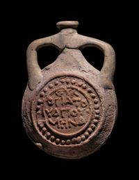A Coptic Terracotta Pilgrim Flask with Saint Menas and Inscription