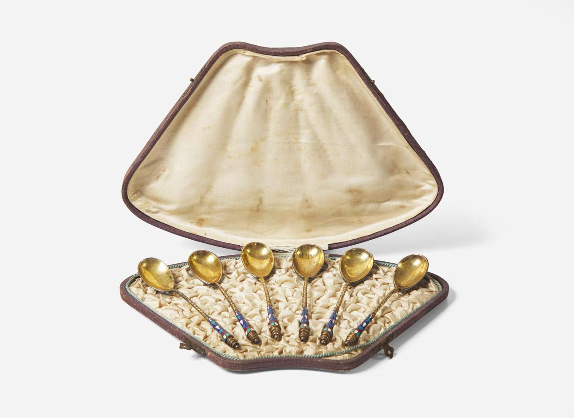 A cased set of six Russian silver gilt and shaded enamel spoons, maker's mark indistinct, Assay master Anatoly Apollonovich Artsybashev, Moscow, 1894