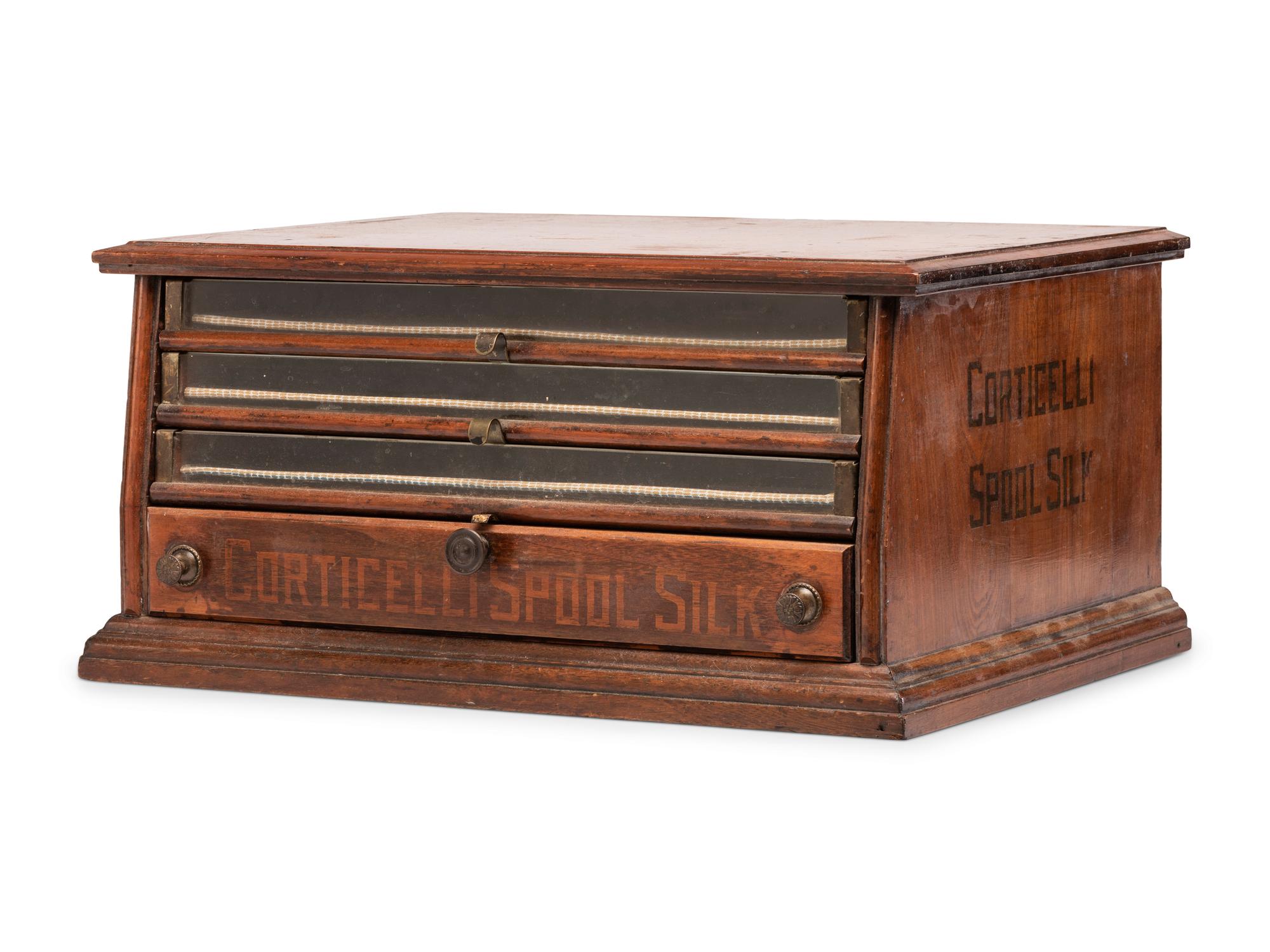 A Corticelli Spool Silk Stenciled Tabletop Spool Cabinet