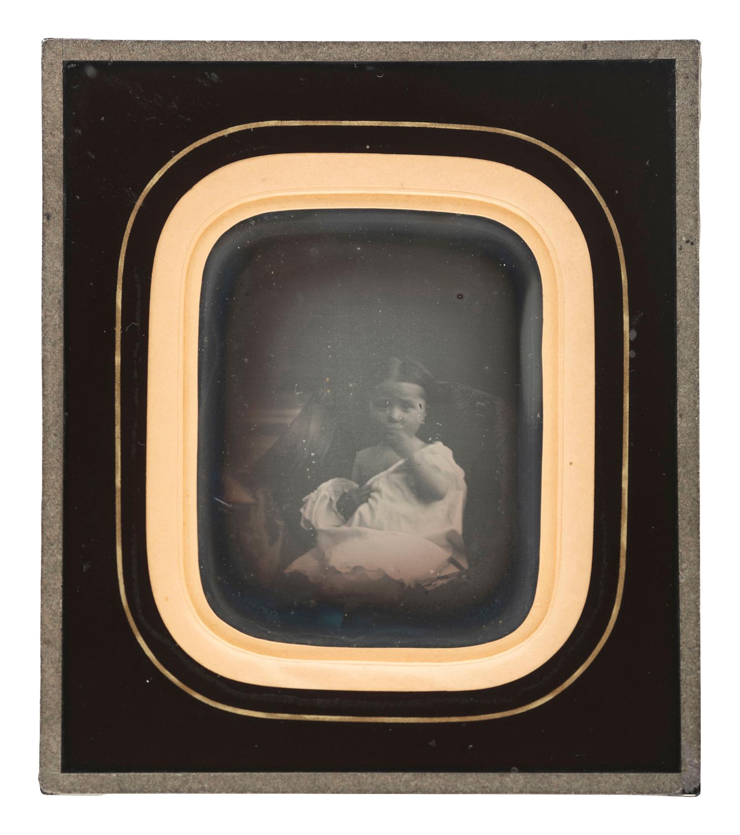 [EARLY PHOTOGRAPHY]. A daguerreotype portrait of a sensitively posed young girl.