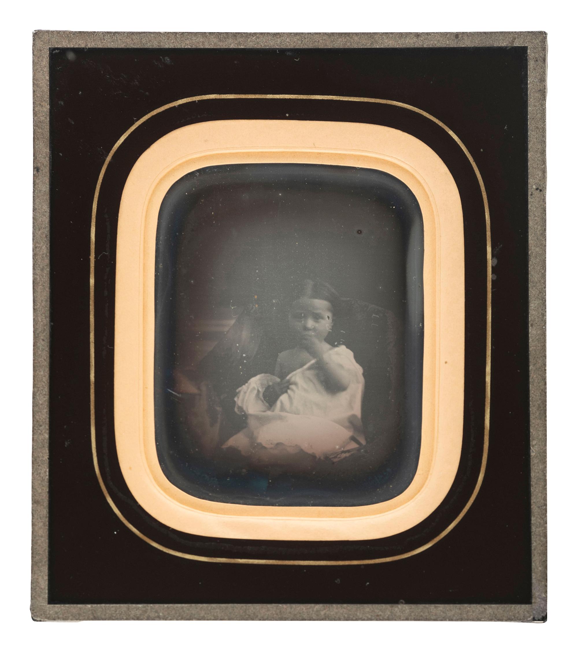 [EARLY PHOTOGRAPHY]. A daguerreotype portrait of a sensitively posed young girl.