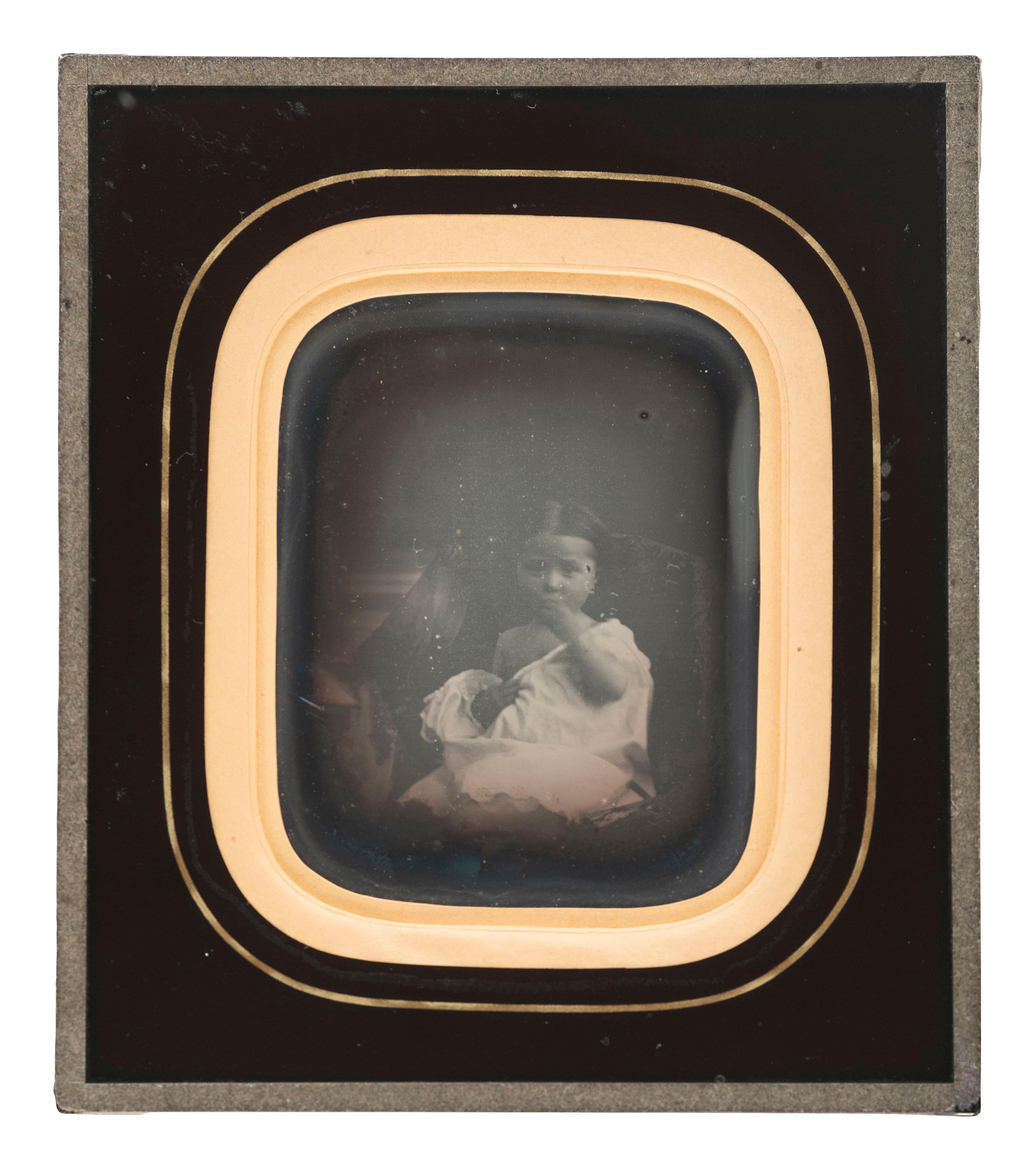 [EARLY PHOTOGRAPHY]. A daguerreotype portrait of a sensitively posed young girl.