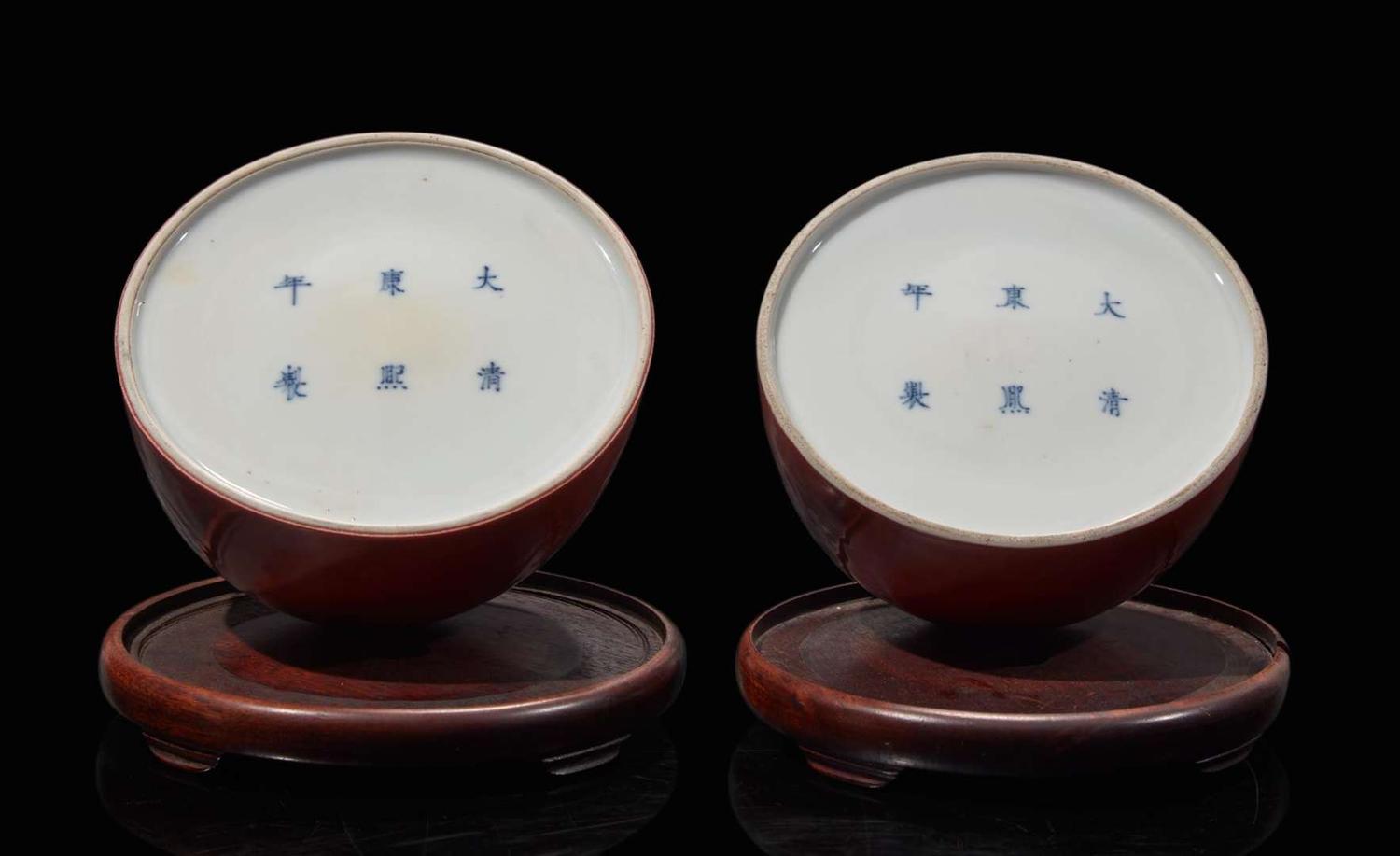 A pair of Chinese iron-red enameled water coupes with hardwood bases 礬紅太白尊一對及木座