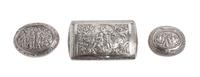 Three Silver Snuff Boxes, , one of rectangular form and two of oval form, having hinged lids chased with figural scenes and foliate scr