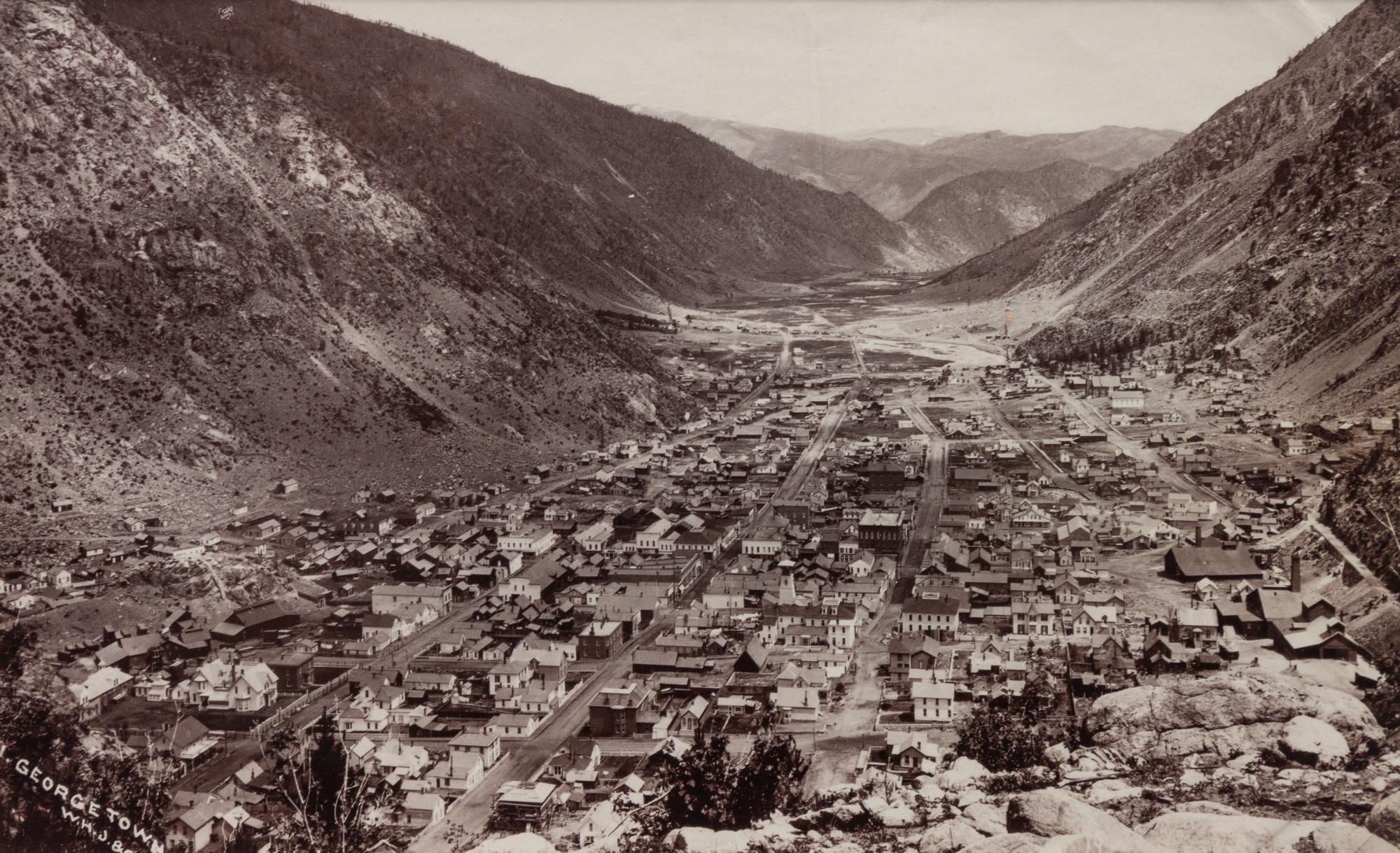 A group of four photographs (8098. Panorama of Denver; Untitled (roof tops of a town; Untitled (mining town); Georgetown)