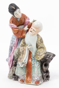 A Chinese Famille Rose Porcelain Figural Group Height 9 inches.