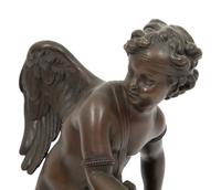 A French Bronze Figure of Eros on a Wood Base
