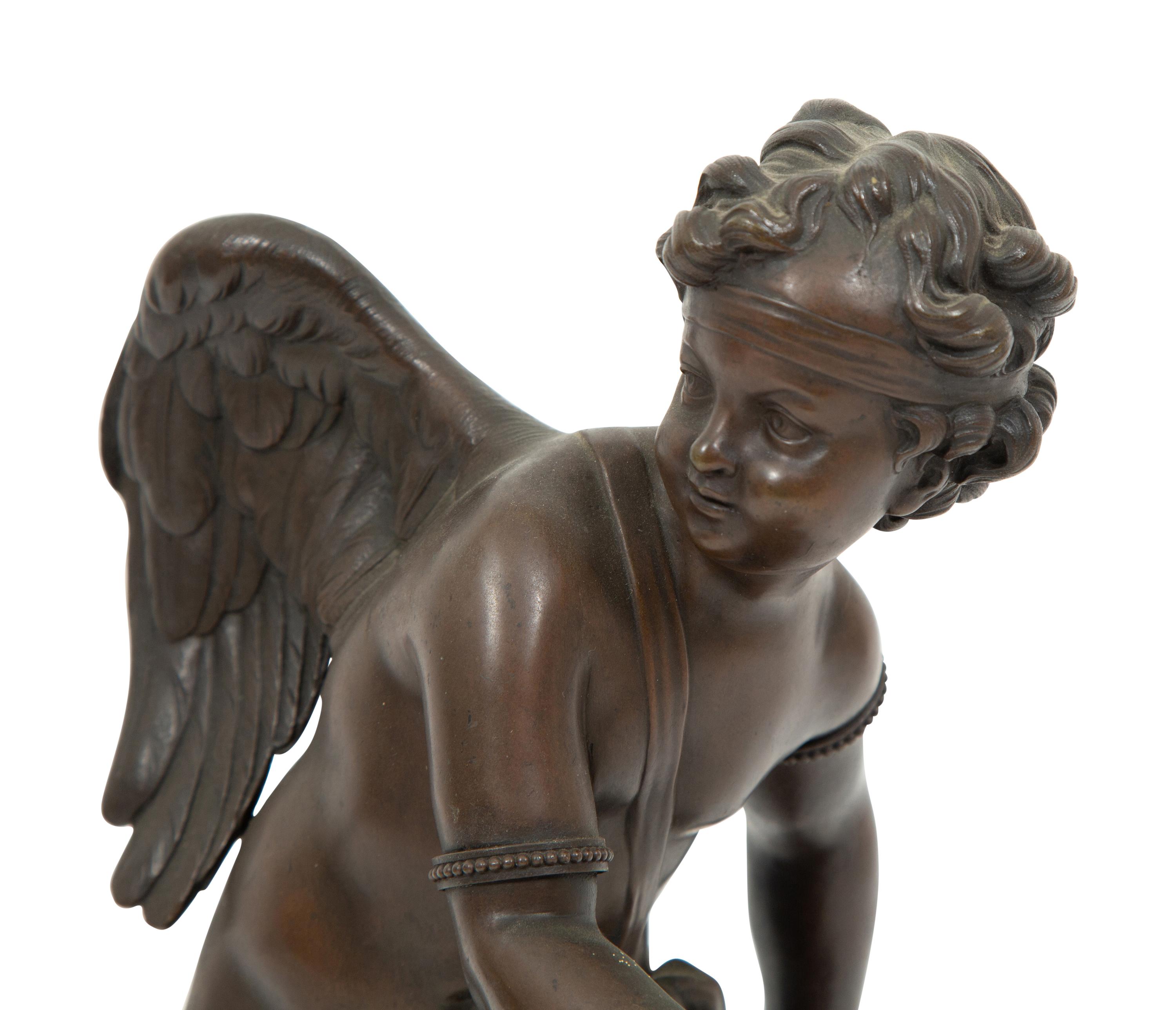 A French Bronze Figure of Eros on a Wood Base