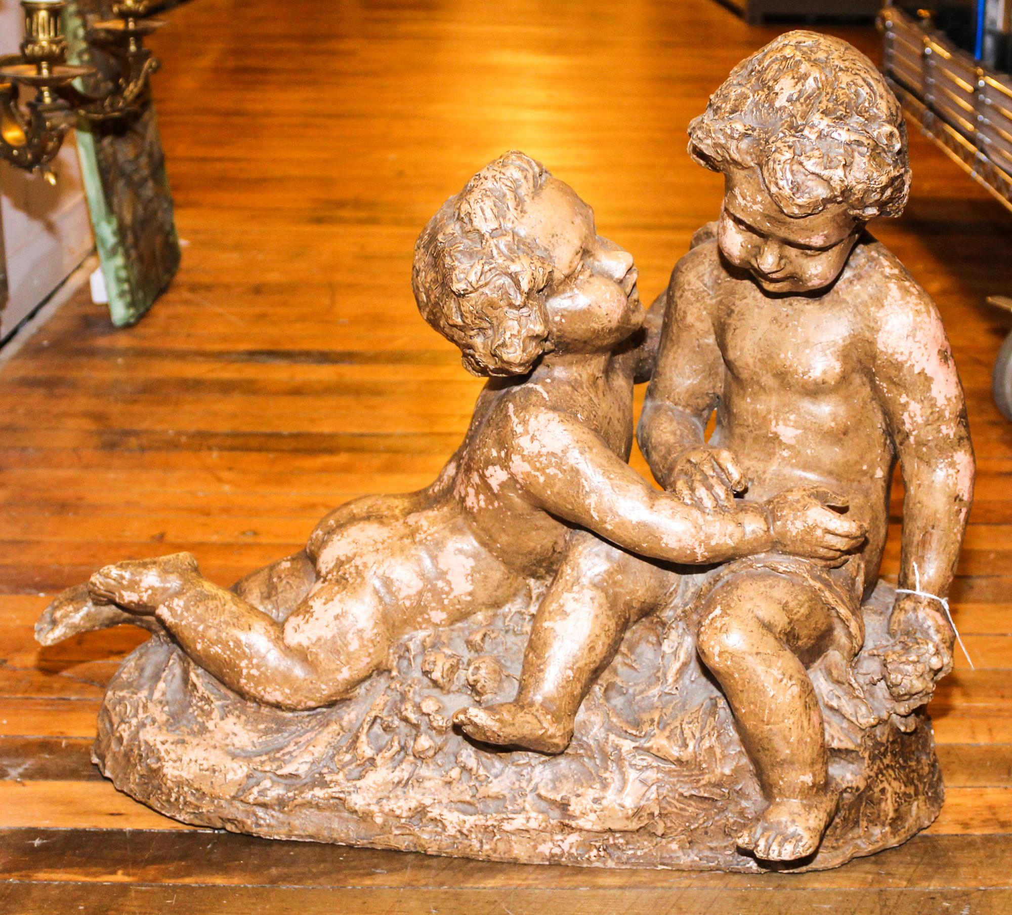 A Terracotta Figural Group. Height 19 1/4 x width 23 inches.