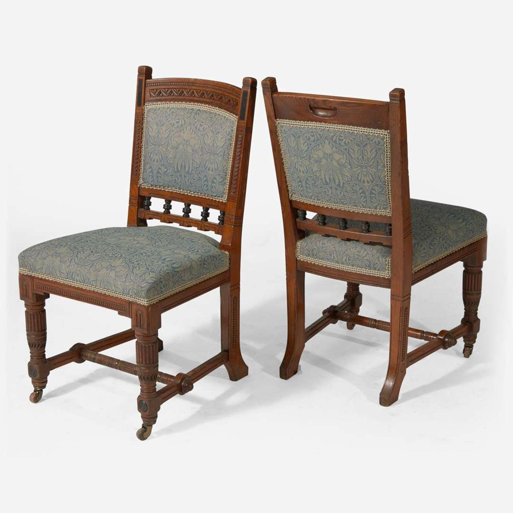 An English Aesthetic Movement carved oak dining table and set of twelve dining chairs Lamb of Manchester, Manchester, England, circa 1875