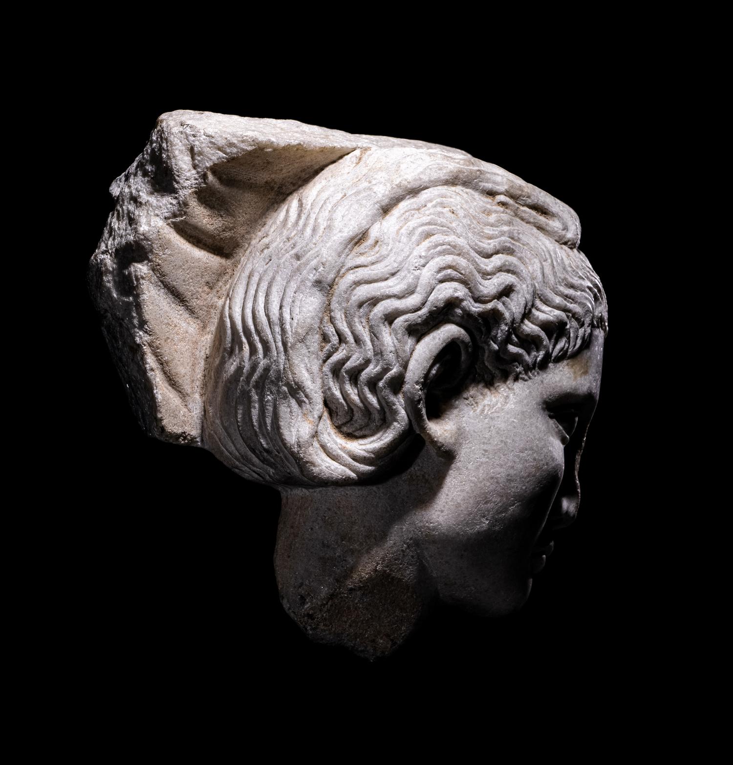 A Roman Marble Relief with a Female Head