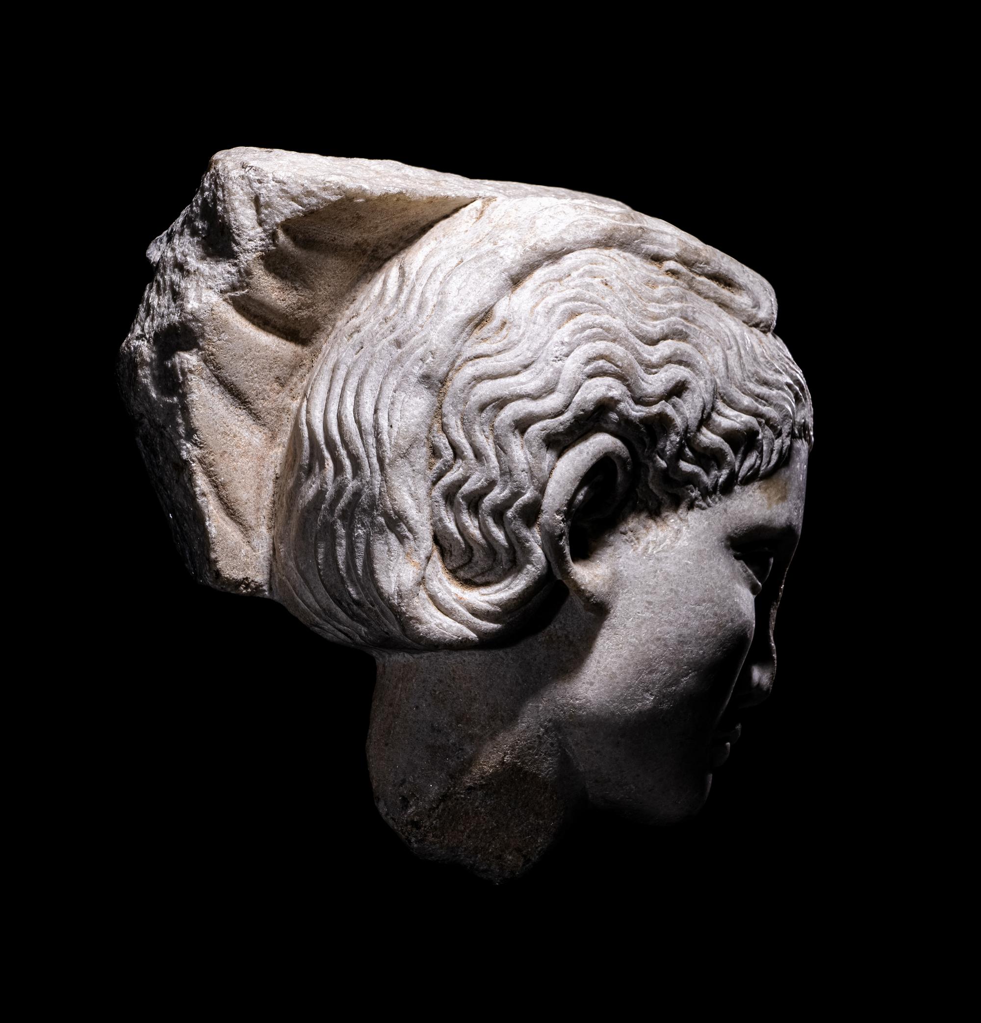 A Roman Marble Relief with a Female Head