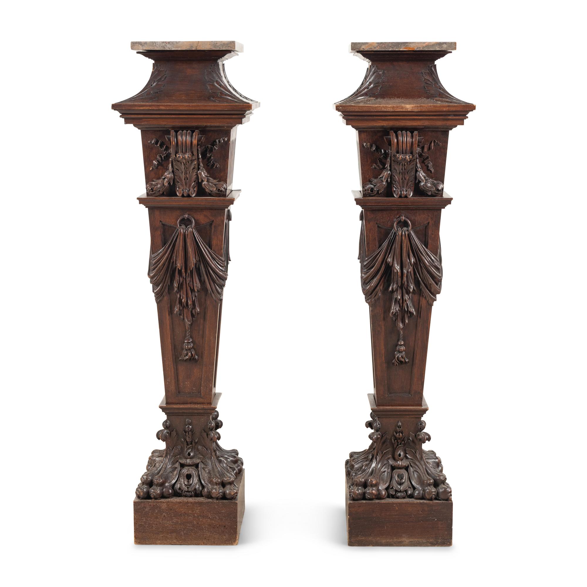 A Pair of English Carved Walnut and Marble Top Pedestals