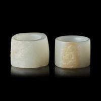 Two Chinese Carved Russet and White Jade Archer's Rings 清 白玉帶沁扳指兩枚