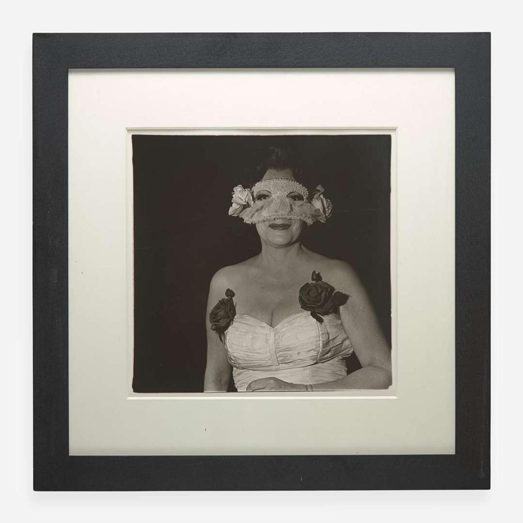 Diane Arbus (American, 1923-1971) Lady at a Masked Ball with Two Roses on her Dress, N.Y.C.
