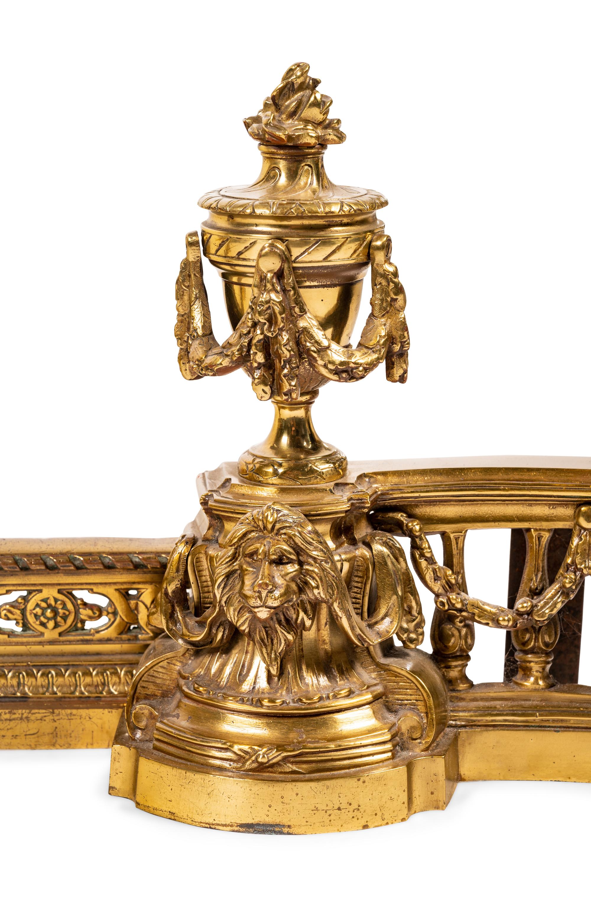 A Louis XVI Style Brass Fire Fender and Chenets