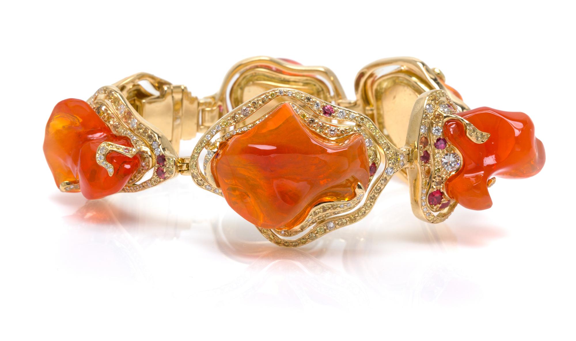 An 18 Karat Yellow Gold, Fire Opal, Colored Diamond, Diamond and Sapphire Bracelet, 52.20 dwts.