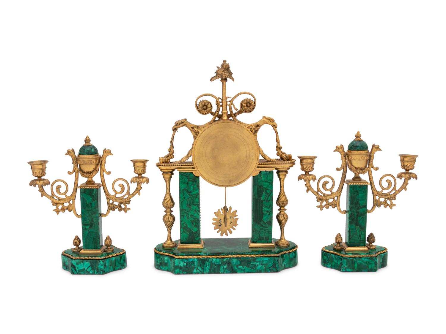A Gilt Bronze and Malachite Veneered Clock Garniture