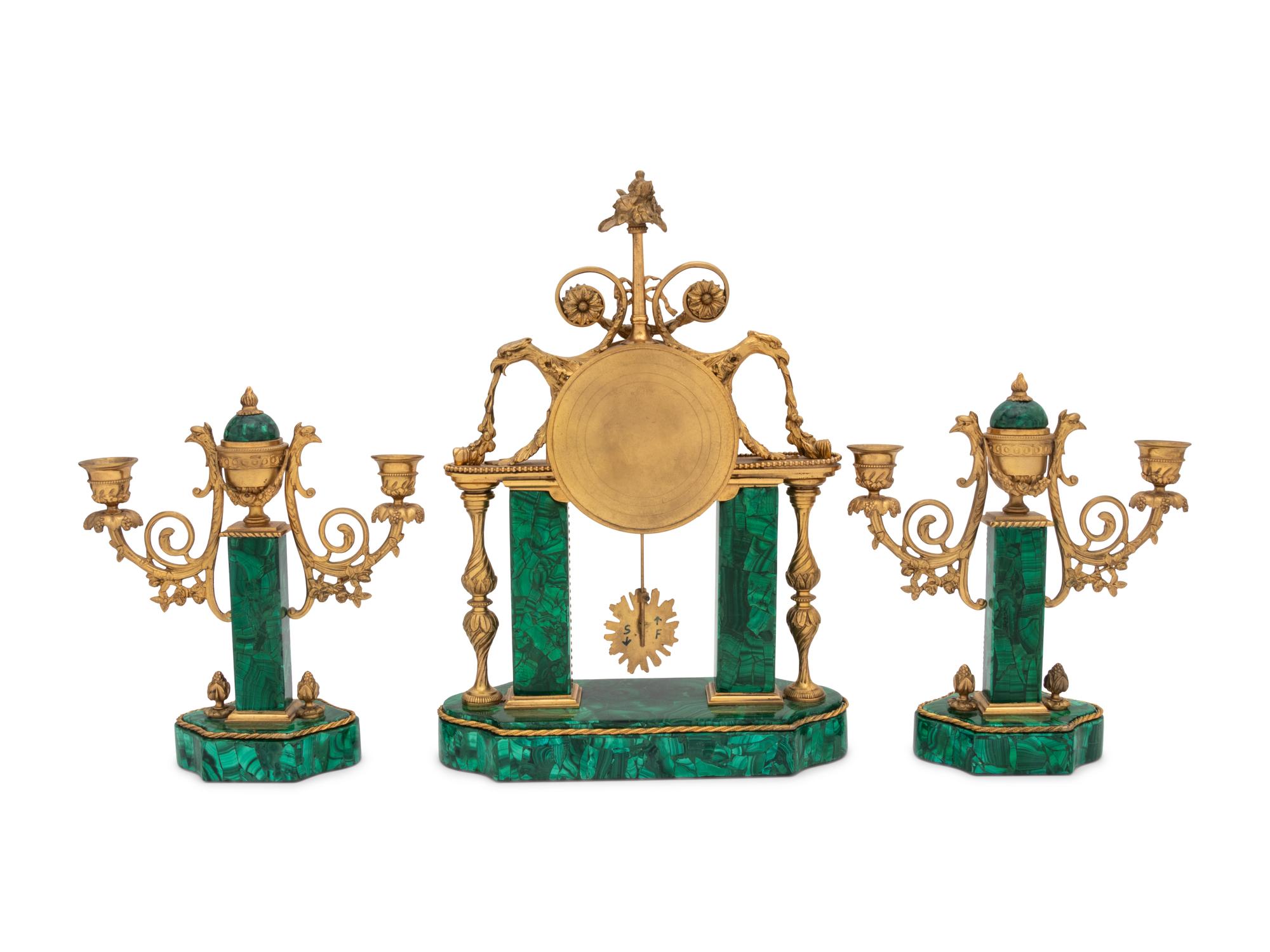 A Gilt Bronze and Malachite Veneered Clock Garniture