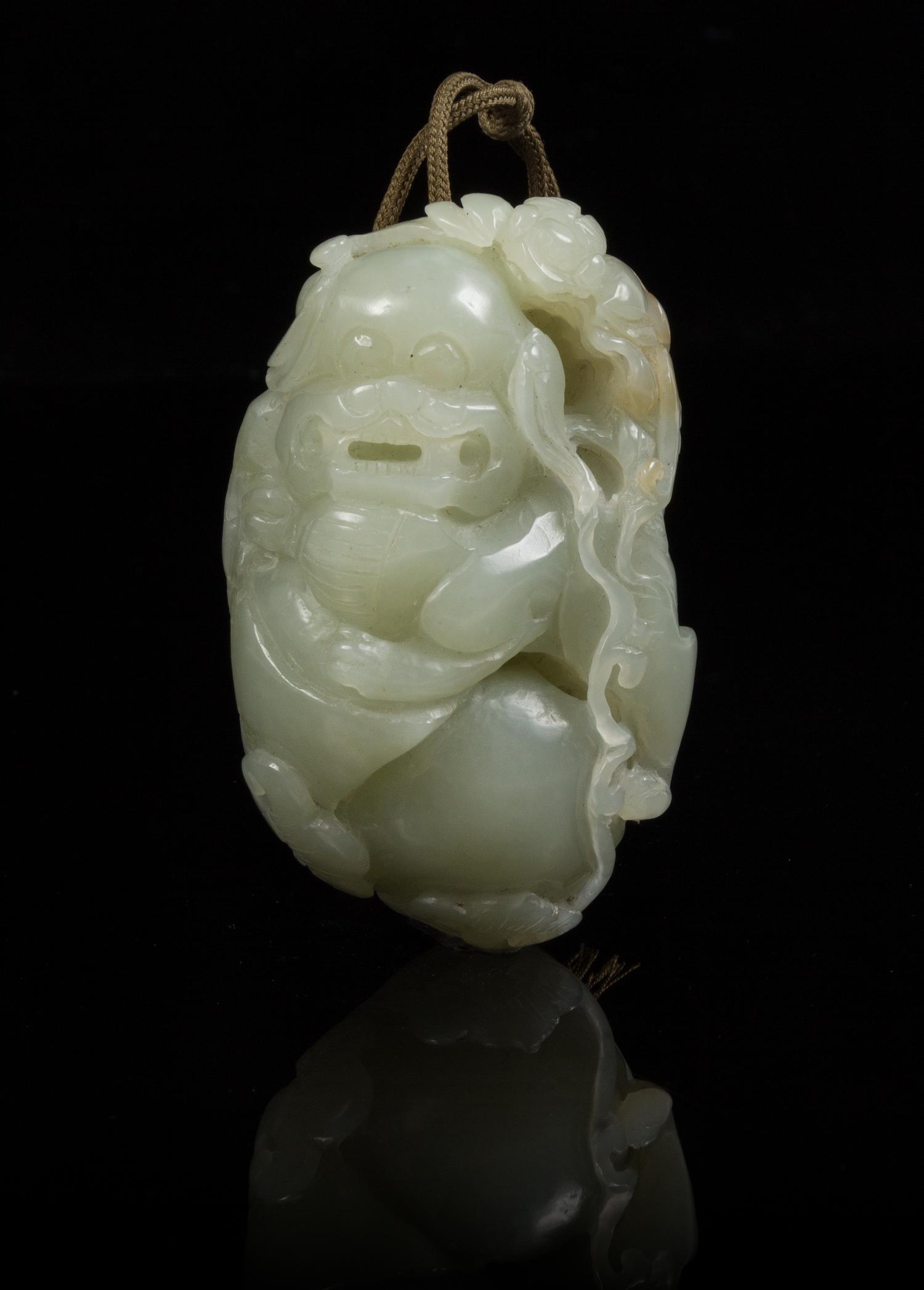 A Carved Jade Toggle Length 2 3/4 inches.