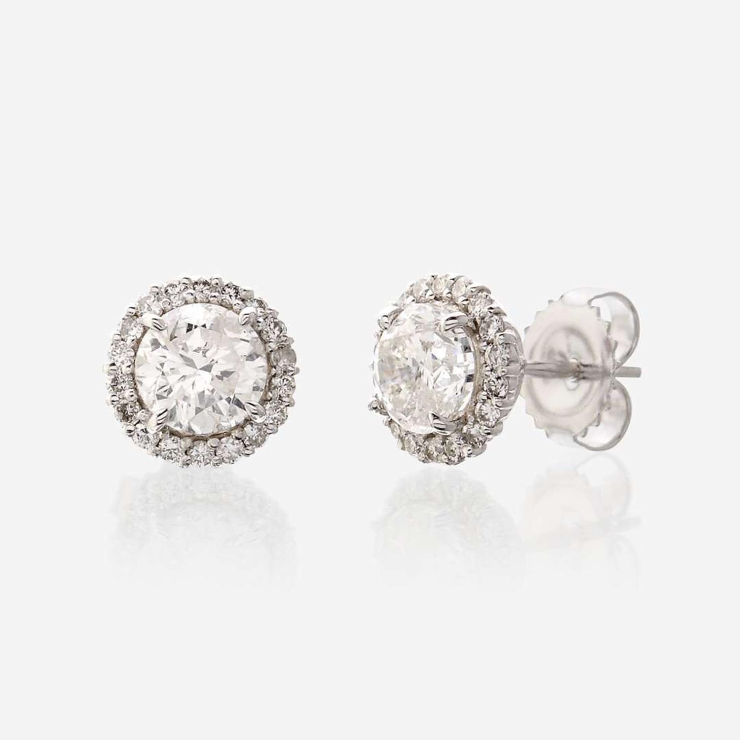 A pair of diamond and eighteen karat white gold earrings