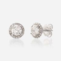 A pair of diamond and eighteen karat white gold earrings