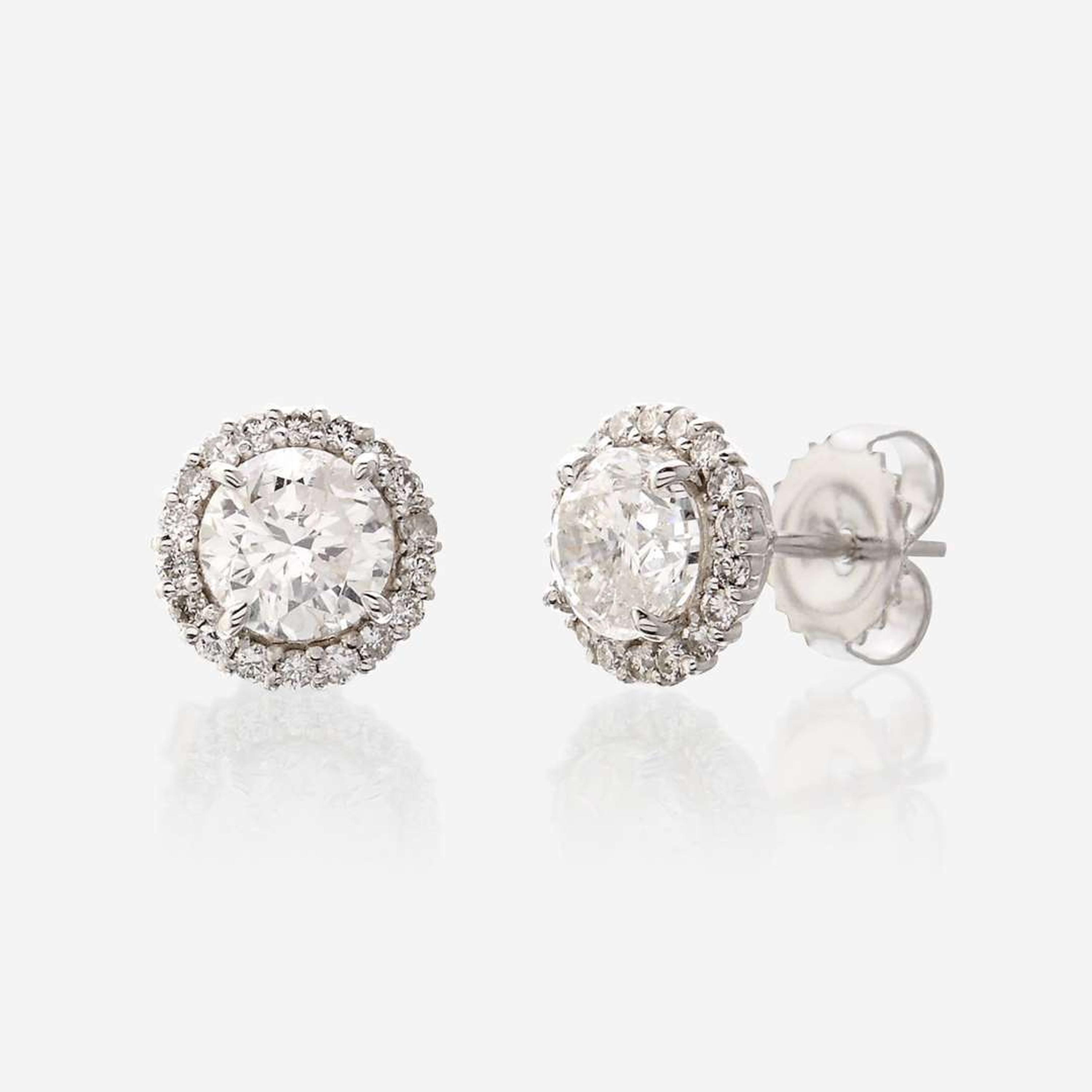 A pair of diamond and eighteen karat white gold earrings
