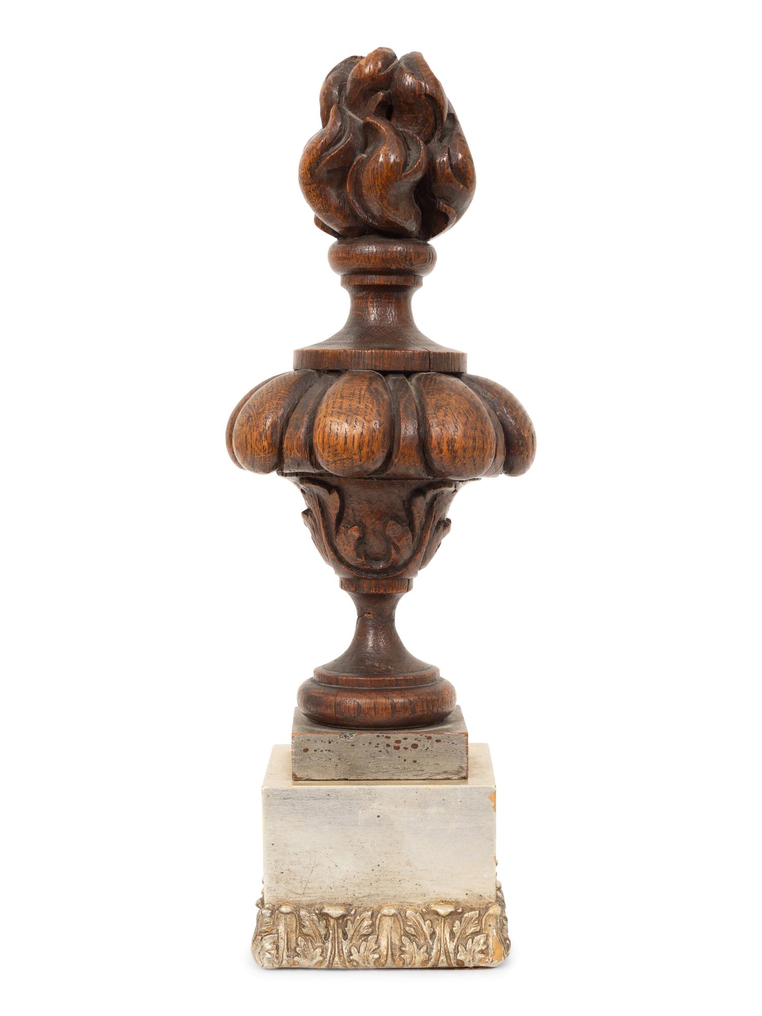 A Carved Oak Flaming Urn Finial Mounted on a Pedestal Base