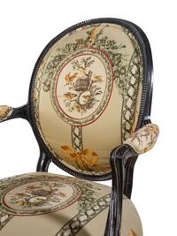 A George III Style Parcel Gilt and Ebonized Armchair