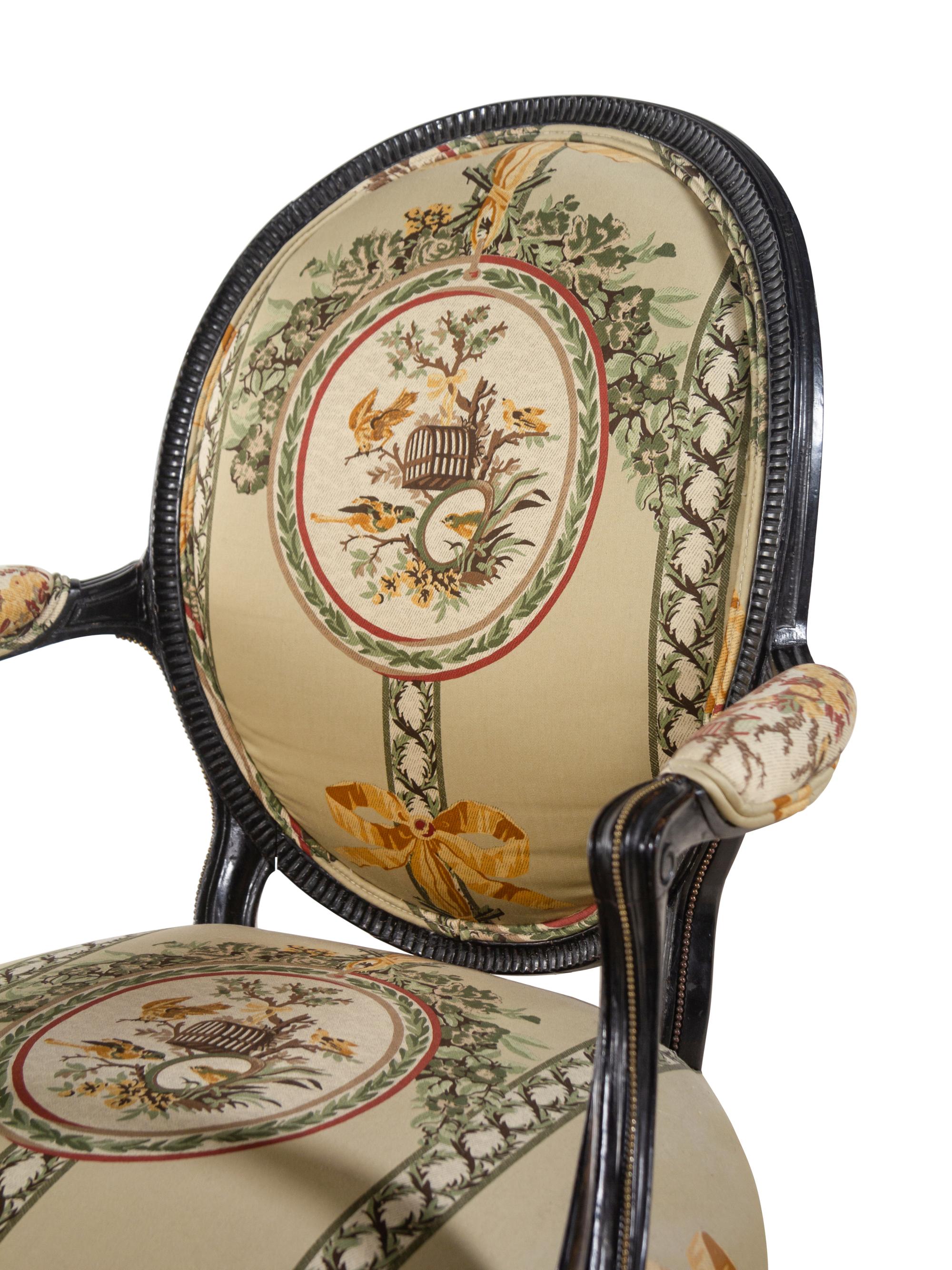 A George III Style Parcel Gilt and Ebonized Armchair