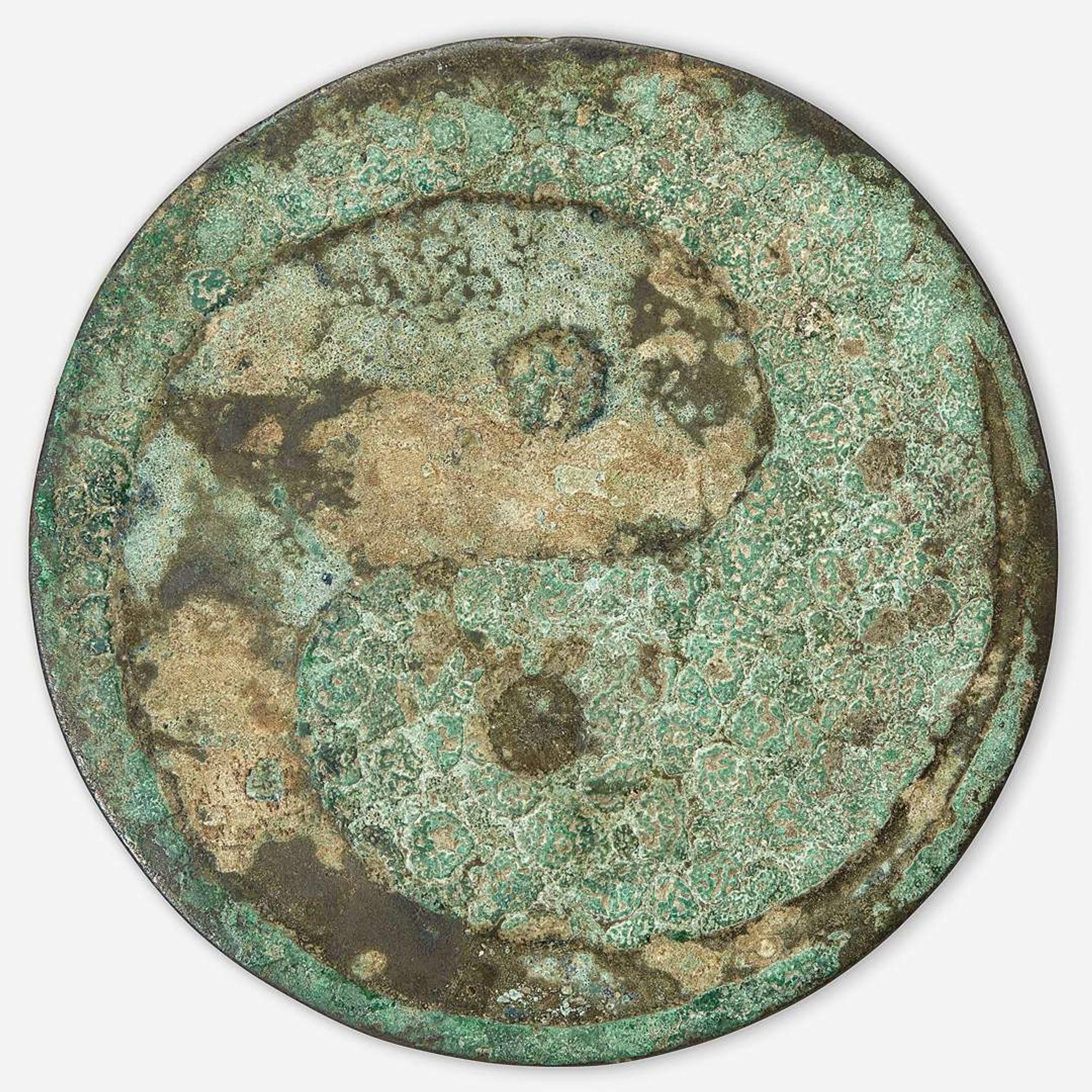 A Chinese bronze "Twin Carp" circular mirror Jin Dynasty (1115-1234)