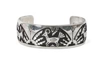 A Hopi Silver Overlay Bracelet, Victor Coochwytewa Length 6 1/4 x opening 1 5/8 x width 1 inch.