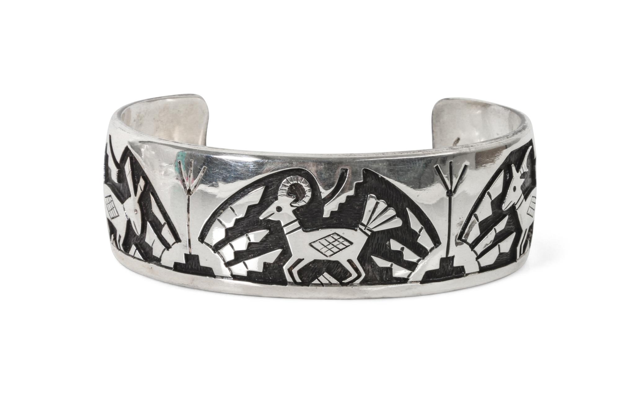 A Hopi Silver Overlay Bracelet, Victor Coochwytewa Length 6 1/4 x opening 1 5/8 x width 1 inch.