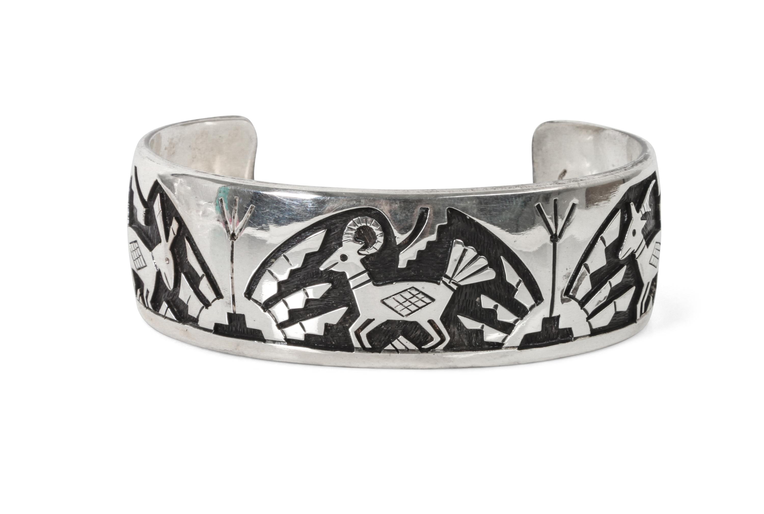 A Hopi Silver Overlay Bracelet, Victor Coochwytewa Length 6 1/4 x opening 1 5/8 x width 1 inch.