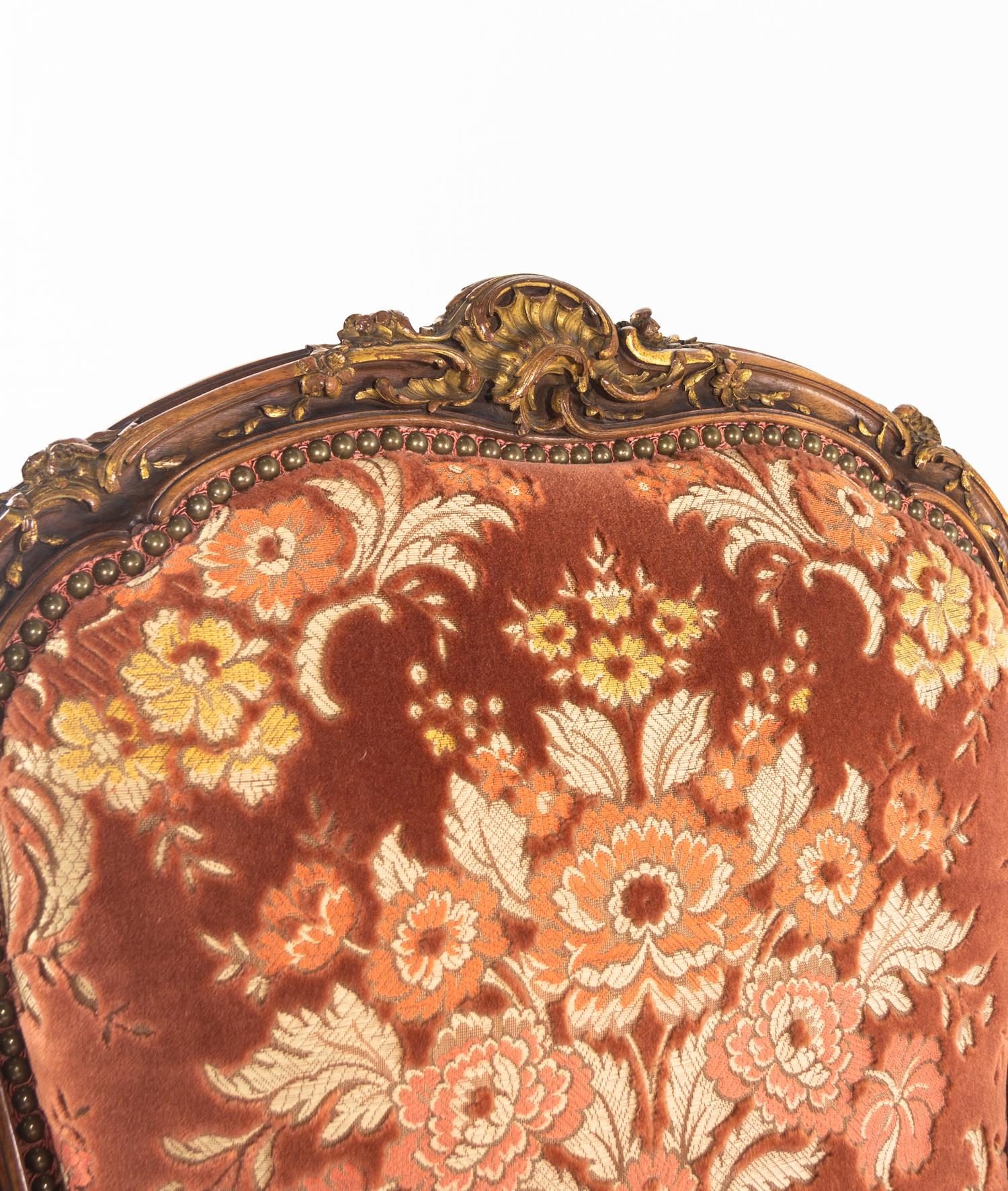 A Louis XV Style Carved and Parcel Gilt Walnut Fauteuil